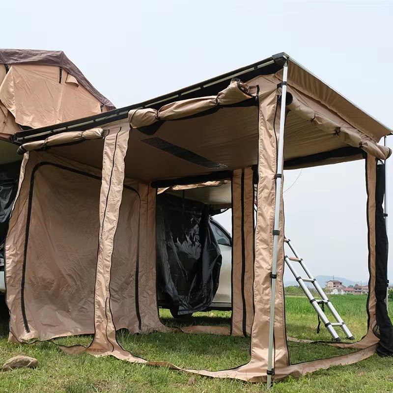 Beige outdoor canopy tent attached to a vehicle on grass with clear sky