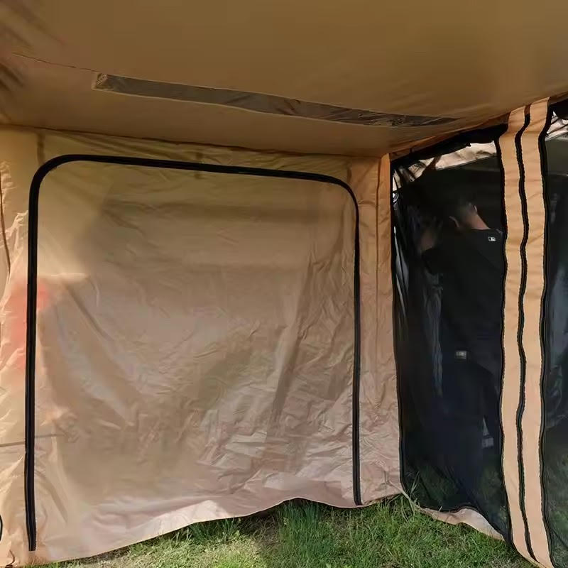 Beige tent with a partially open door on grass